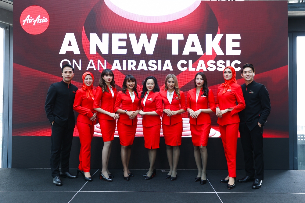 Hijab-friendly uniforms take flight as AirAsia lets its crew put their own spin on red